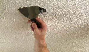 Popcorn ceiling material being checked for possible asbestos content